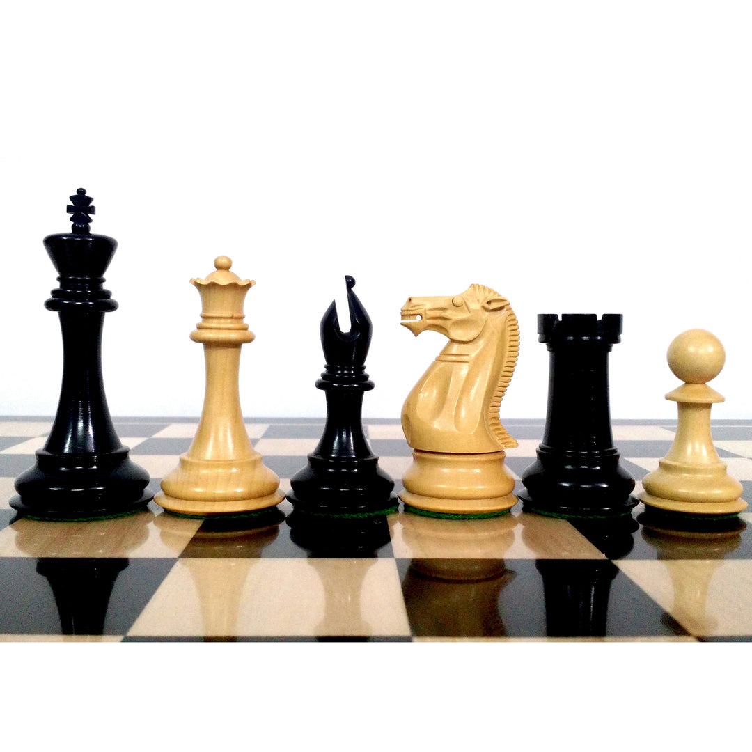 Sleek Staunton ebony and boxwood chess pieces lined up on an ebony and maple board.