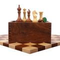 Zadar series minimalist chess set featuring golden rosewood and boxwood pieces balanced on a slide-top wooden box.