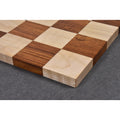High-angle close-up of a borderless wooden chess board corner highlighting premium solid wood craftsmanship.