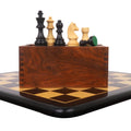 Tournament chess pieces arranged on a wooden storage box over an ebony and maple board.