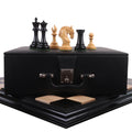 Imperator Staunton chess pieces on a black leatherette storage box and ebony board.