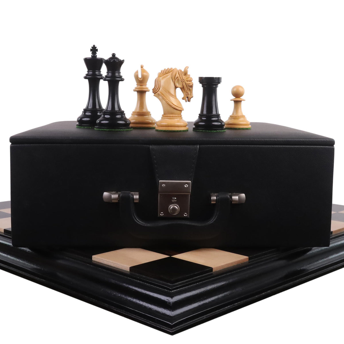 Imperator Staunton chess pieces on a black leatherette storage box and ebony board.