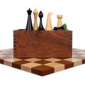 Hermann Ohme chess pieces in ebonised boxwood displayed with a golden rosewood board and storage box.