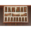 Dark Staunton chess pieces neatly organized inside the velvet-lined storage drawer.