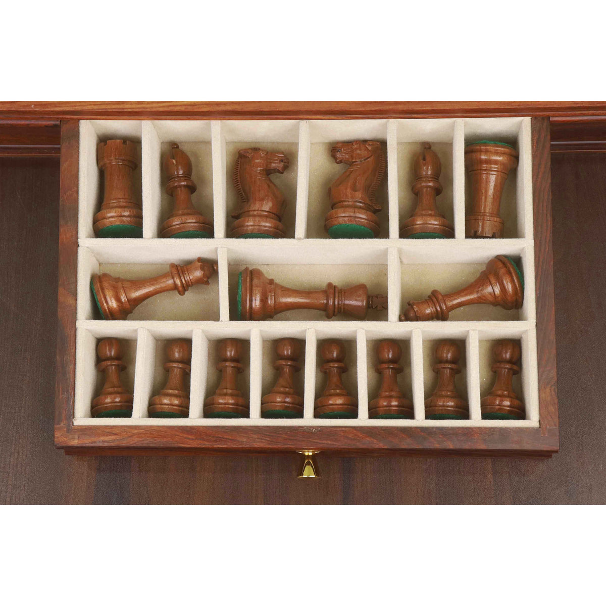 Dark Staunton chess pieces neatly organized inside the velvet-lined storage drawer.