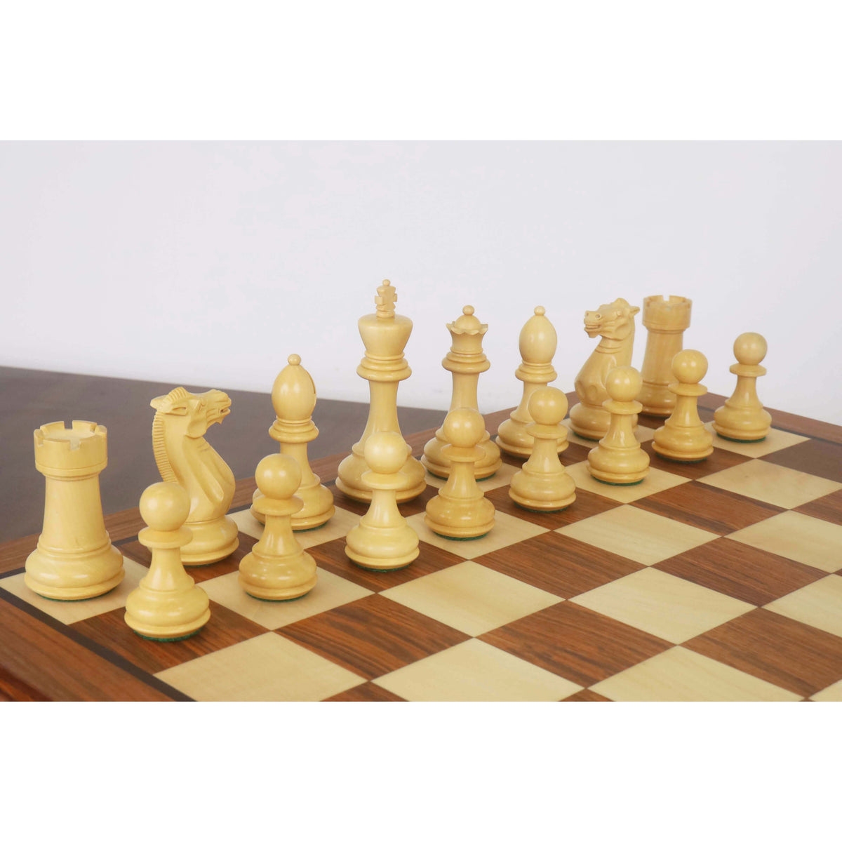 Classic white Staunton chess pieces arranged on a luxury 20-inch golden rosewood board.