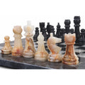 White onyx Staunton chess pieces showcasing natural stone patterns on a marble board.