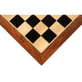 Close-up corner view of a 21 inch Ebony and Maple wood chessboard with Golden Rosewood borders.