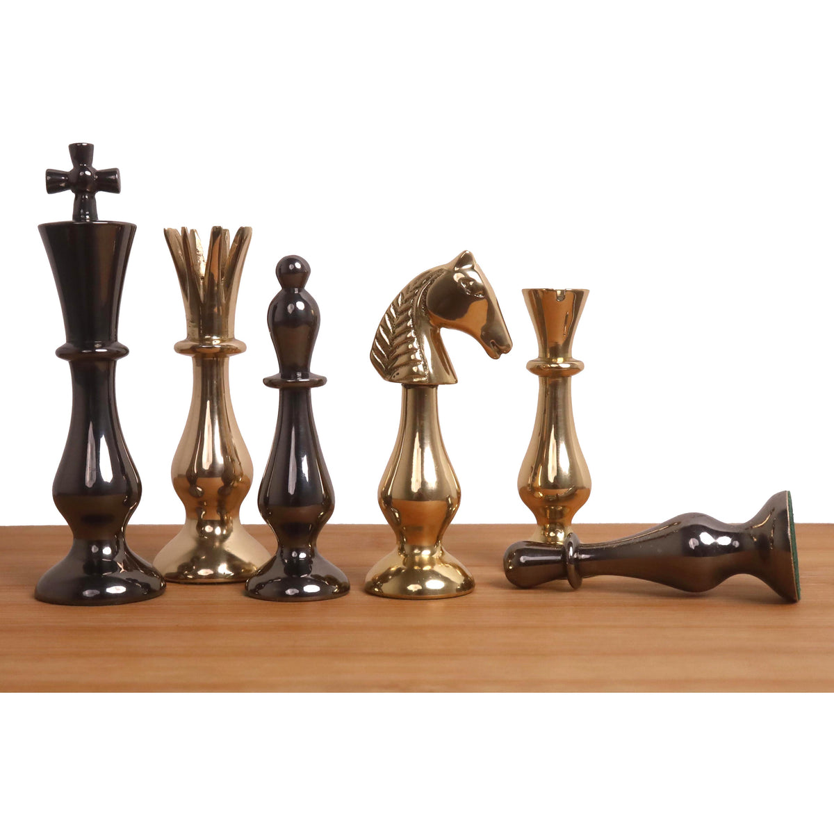 Gold and metallic grey brass chess pieces from the Regal Curve Series.
