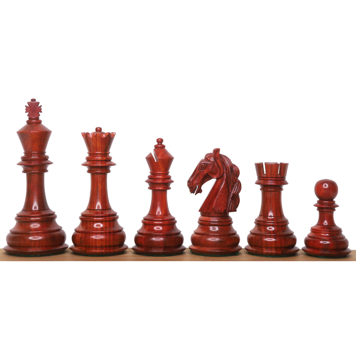 Six handcrafted rare Columbian bud rosewood luxury chess pieces arranged linearly.