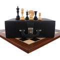 A complete Goliath Series Ebony wood chess set, pieces, board, and storage box, displayed together on a white background.