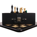 Repro 2016 Sinquefield Staunton chess set pieces on a leatherette storage box and ebony board.