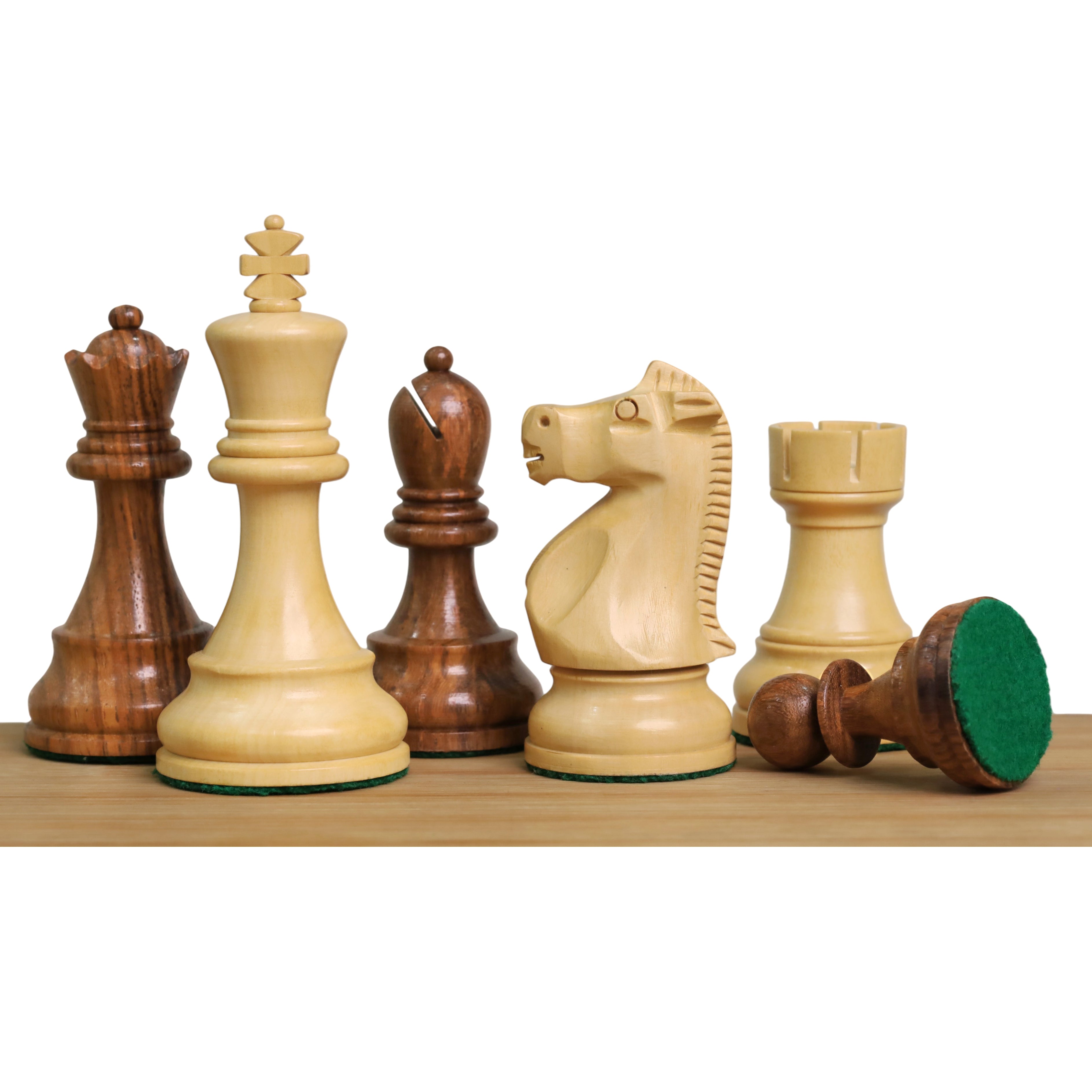 A group of 1972 Fischer Spassky World Championship design chess pieces in Golden Rosewood and Boxwood showing the green felt base.