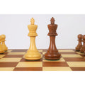 Light and dark Staunton king chess pieces together on the board.
