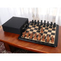1900s American reproduction chess set featuring antiqued boxwood pieces on an ebony board.