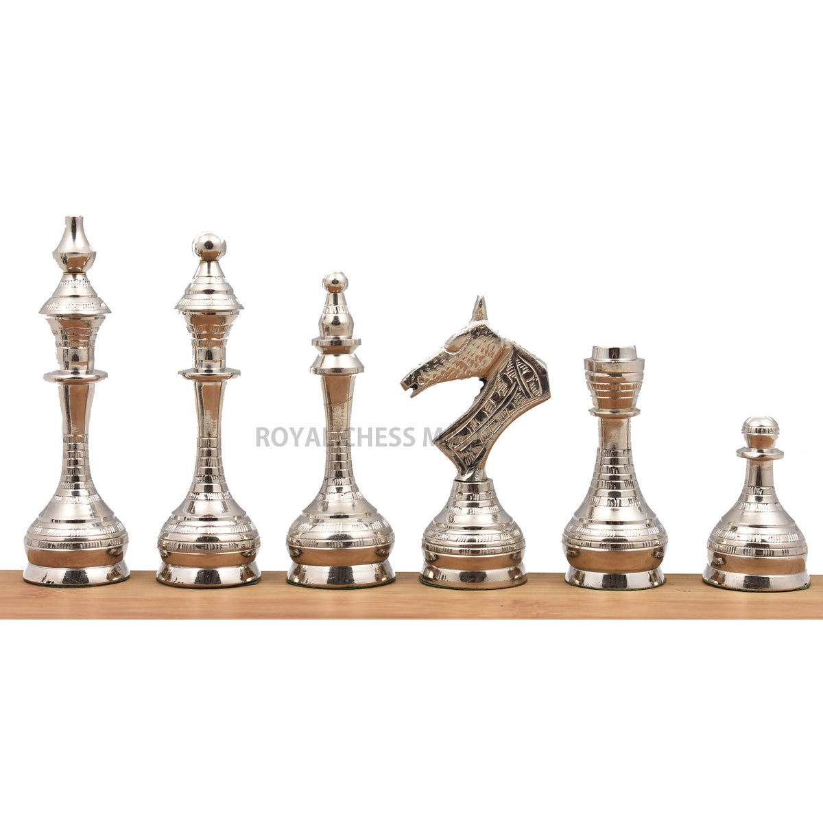 Line-up of silver Soviet-inspired brass metal chess pieces.
