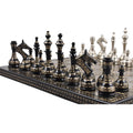 Angled lineup of black Soviet-inspired brass metal chess pieces.