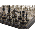 Partial view of black Soviet-inspired brass chess pieces on the board.

