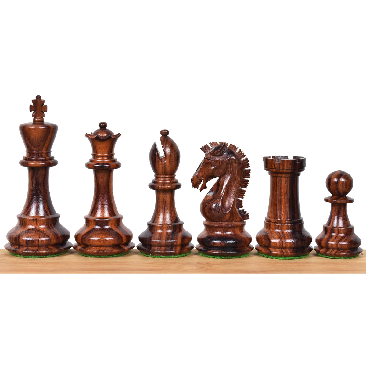 Close-up of rosewood Craftsman Staunton pieces lined up in a row.