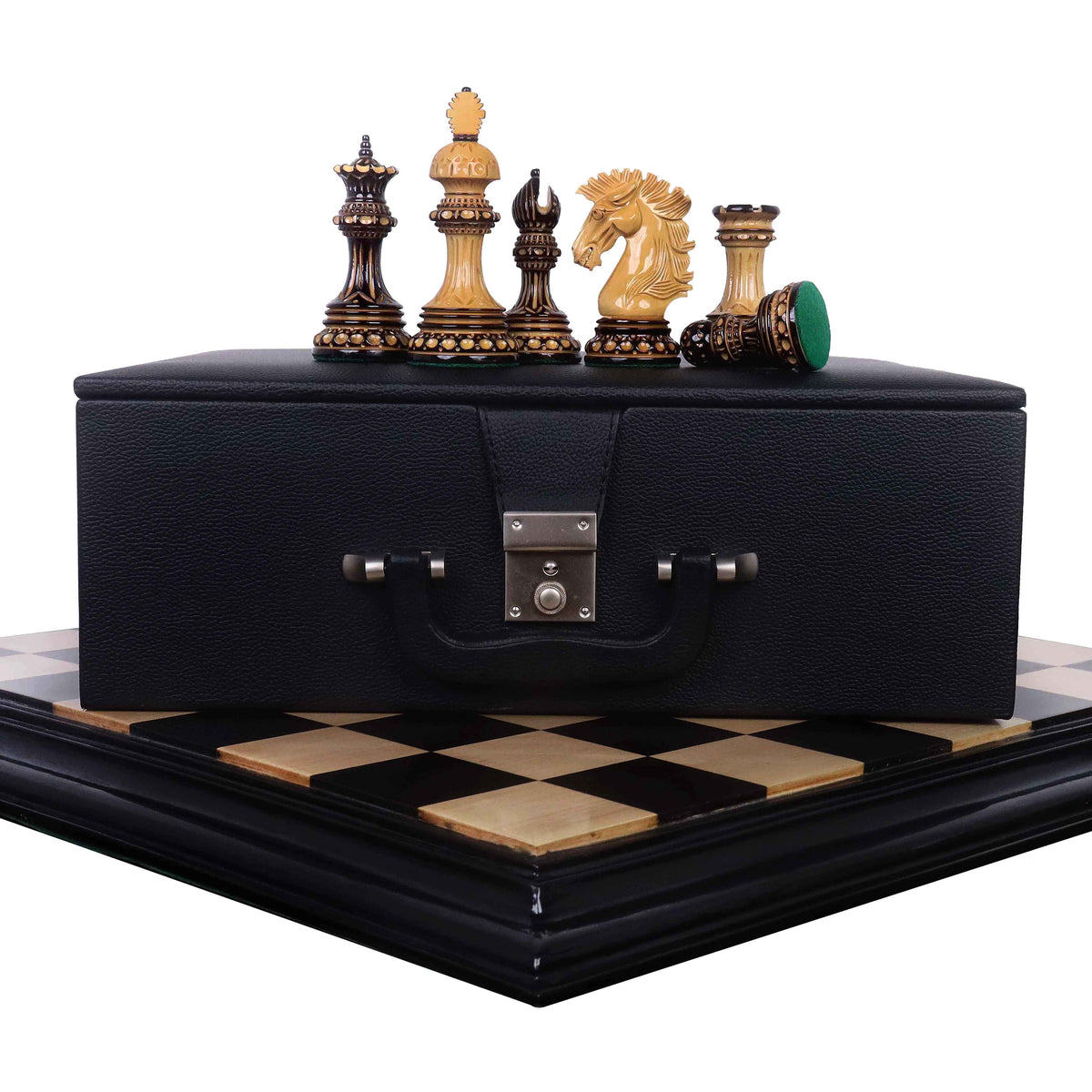 Five burnt carving Staunton chess pieces displayed on a black leatherette storage case and wooden chess board.