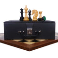 Mogul Staunton ebony chess pieces displayed with their luxury storage case on a chess board.