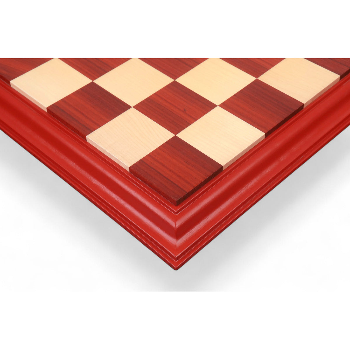Top view of a 23 inch luxury chessboard featuring Bud Rosewood and Maple wood squares with a decorative carved border.