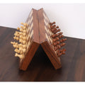 Folding magnetic travel chess set in golden rosewood demonstrating strong magnetic grip.