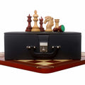 Alexandria Staunton luxury chess pieces arranged on a premium black leatherette storage box over a wooden board.