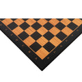 Close-up corner view of a 21" wooden printed chess board featuring antique boxwood and ebony squares with clear algebraic notations.