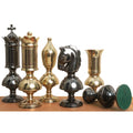 Six giant Victorian brass luxury chess pieces in gold and grey finishes, including one resting on its side.