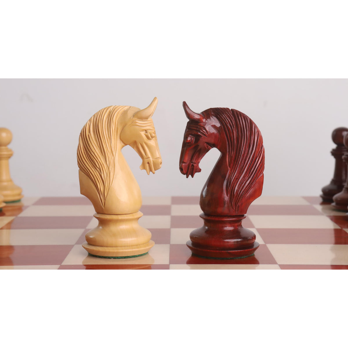 Finely carved knights from the 4.6 inch Bath luxury Staunton chess pieces set facing each other.