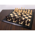 A complete 5-inch Piatigorsky Cup reproduction chess set displayed on a wooden board with extra queens.