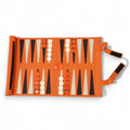 Overhead view of a portable orange roll-up backgammon set laid out for play.