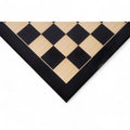 Close-up of a 26 inch ebony and maple wood printed chess board corner with a high-gloss finish.