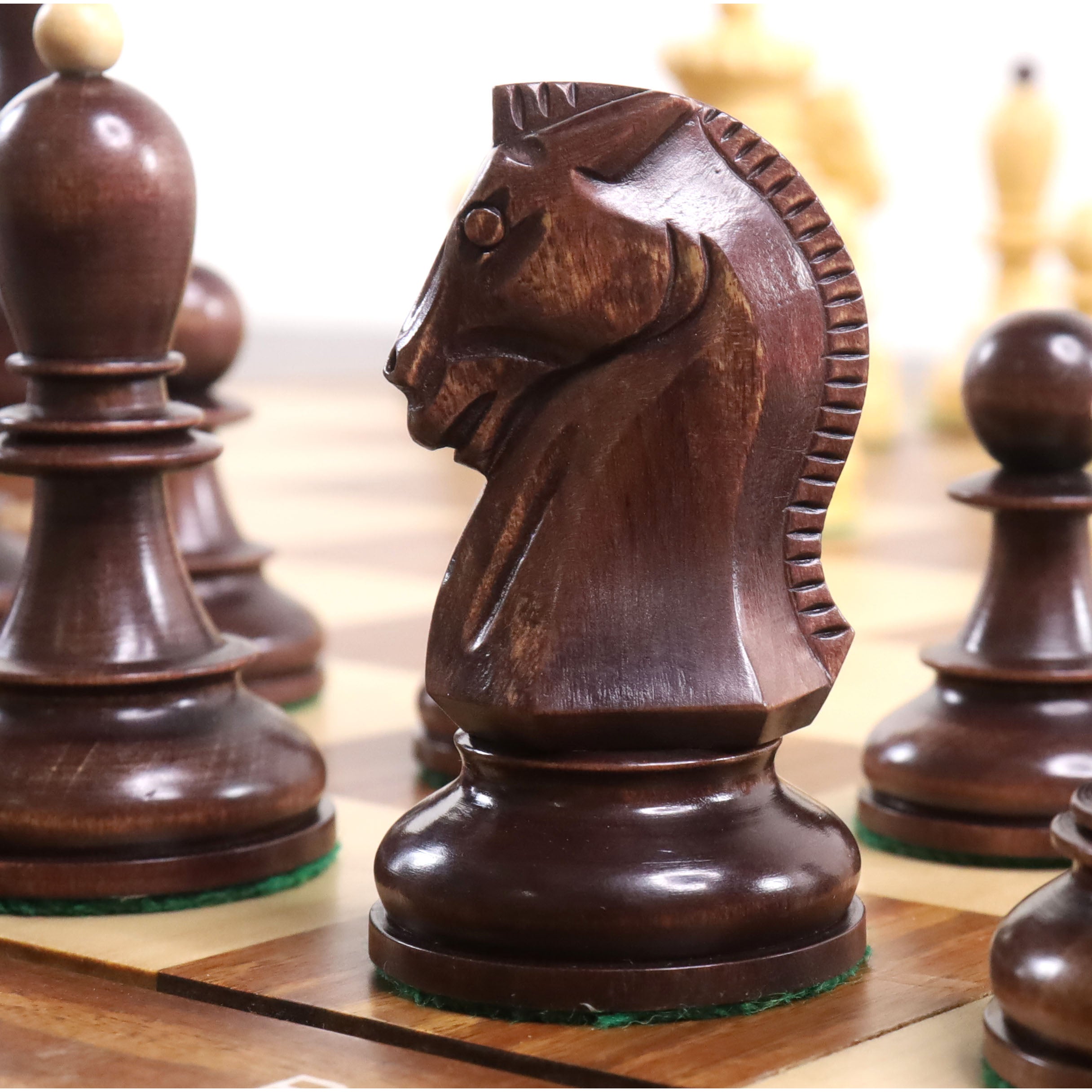 Side profile close-up of a mahogany stained Fischer Dubrovnik wooden chess knight piece.