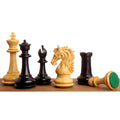 Heritage Series Staunton chess pieces in ebony and boxwood arranged on a wooden surface.