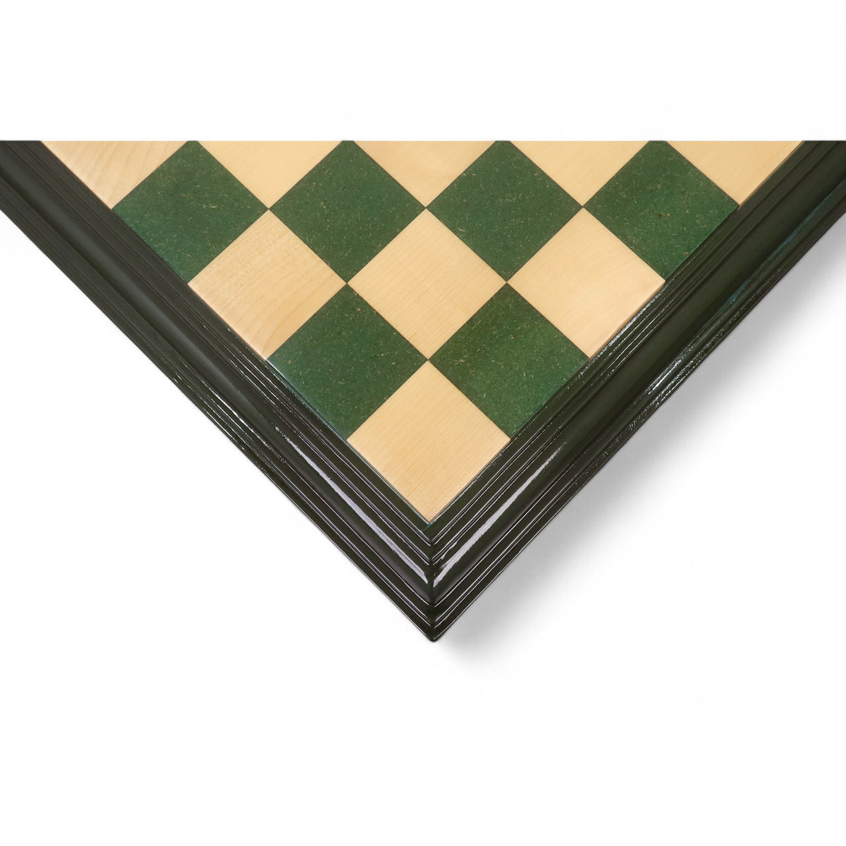 Corner detail of a handcrafted green and maple wood chess board with decorative tiered edges.