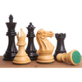 Mixed ebony and boxwood Staunton chess pieces including a knight, with one pawn displaying green felt felted base.