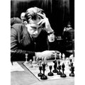 Historical photograph of a chess player using an Averbakh Soviet chess set.