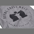 Close-up of the Royal Chess Mall logo printed on a grey velvet travel chess set storage bag.