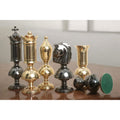 A lineup of luxury brass metal chess set pieces arranged side-by-side to display individual designs.