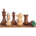 Staunton chess pieces in golden rosewood and boxwood featuring unique chamfered bases.