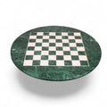 A 24-inch luxury round chess board crafted from dark green marble with inlaid white semi-precious stone squares, isolated on a white background.