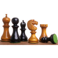 Mixed Antiqued and Ebonised Boxwood English Dublin chess pieces with a fallen black pawn on a wooden surface.