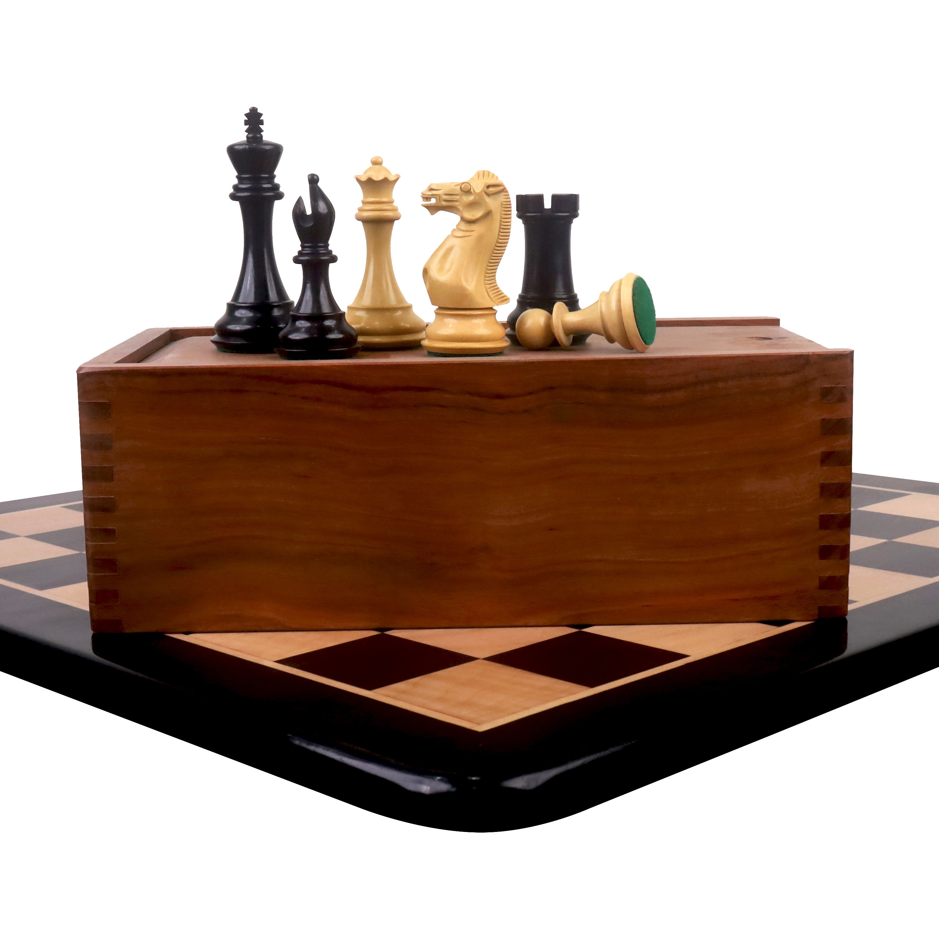 Sleek Staunton ebony chess pieces set atop a wooden storage box on a maple chessboard.