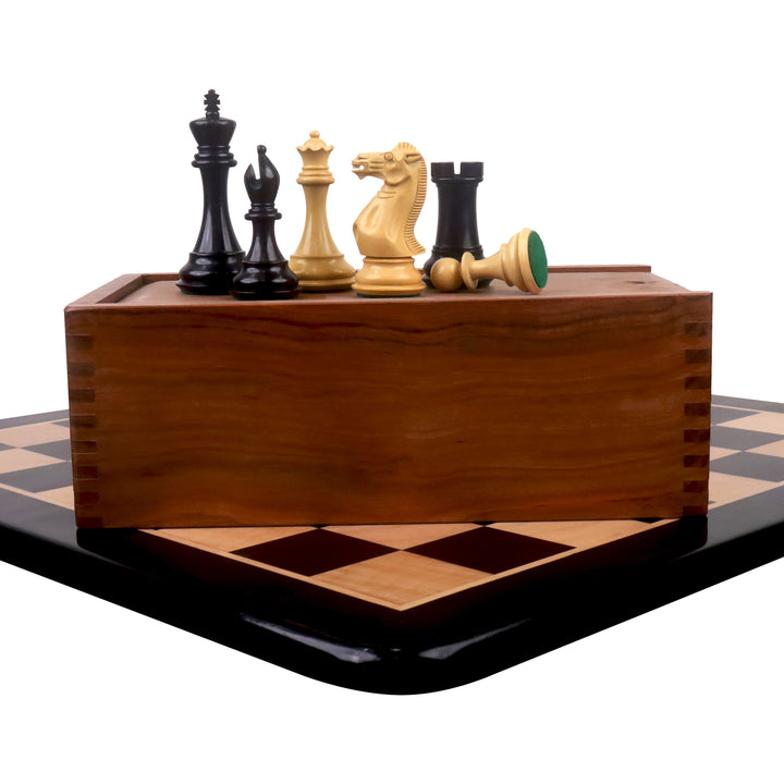 Sleek Staunton ebony chess pieces set atop a wooden storage box on a maple chessboard.