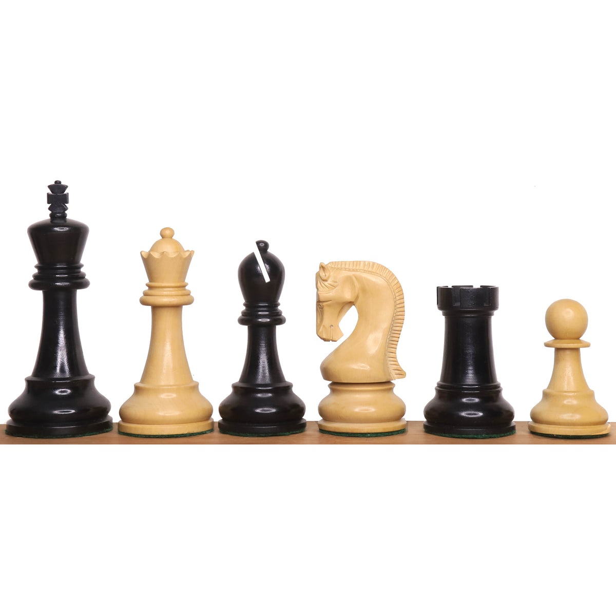 The 4-inch Leningrad Staunton chess set pieces in ebonised boxwood, lined up on a surface.
