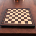 A 21-inch Tiger Ebony and Maple wood printed chess board displayed on a dark wooden table in a lifestyle setting.