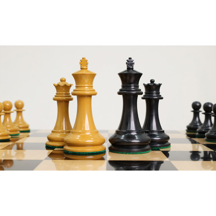 Hand-carved king and queen chess pieces on a wooden tournament board