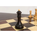 Mahogany stained boxwood Queen of the 3.8" Candidates Series Minimalist chess set positioned on a wooden board.